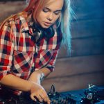 cute dj woman having fun playing music at club party