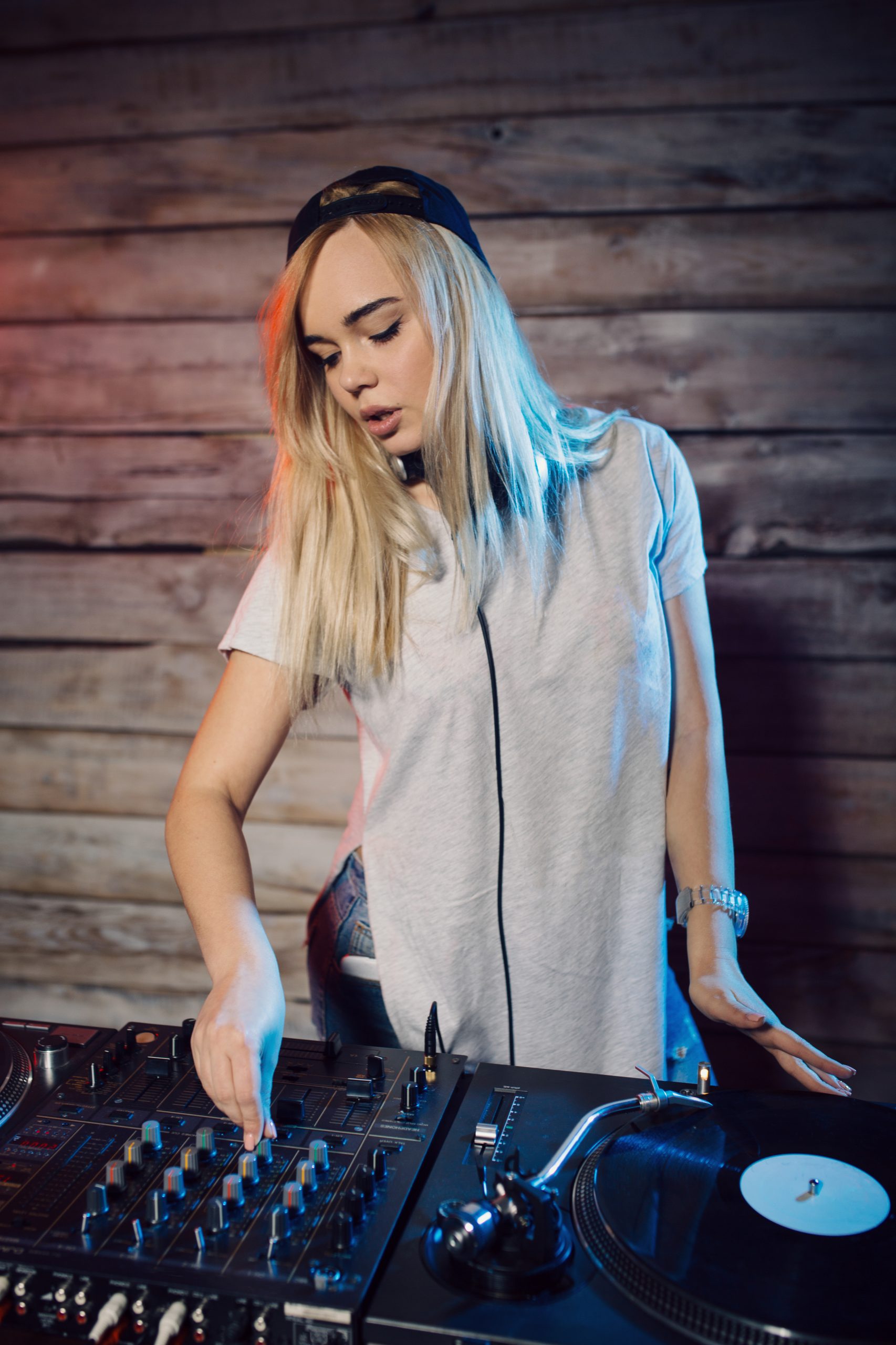 cute dj woman having fun playing music at club party
